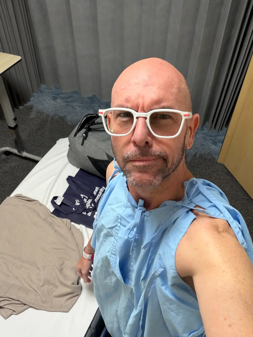 Adam wearing a hospital gown shortly before hamstring surgery